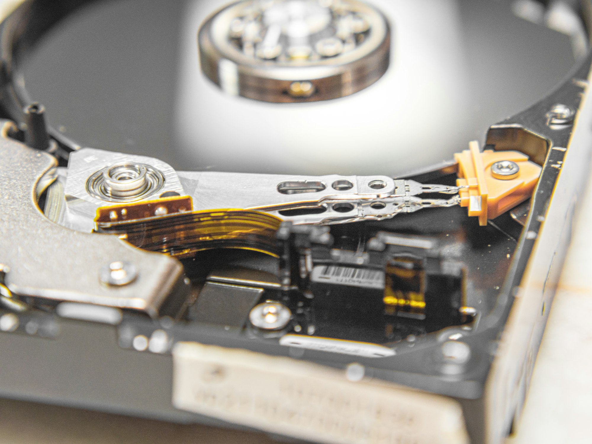 Close-up of a black and silver hard disk drive with its platter exposed