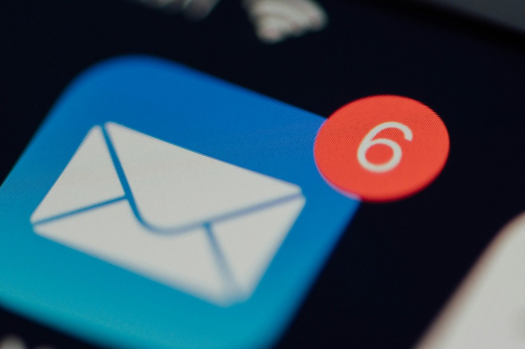 Close-up of a mail app icon on a phone screen showing six unread messages